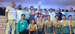 Boys Under-14 Handball Team of Nosegay Public School Sri Ganganagar with the championship trophy after winning the CBSE West Zone Handball Tournament 2026.